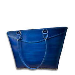 Blue Kimbia tote bag made from Argentinian leather featuring an exterior pocket and two straps made by Gy Crafts.