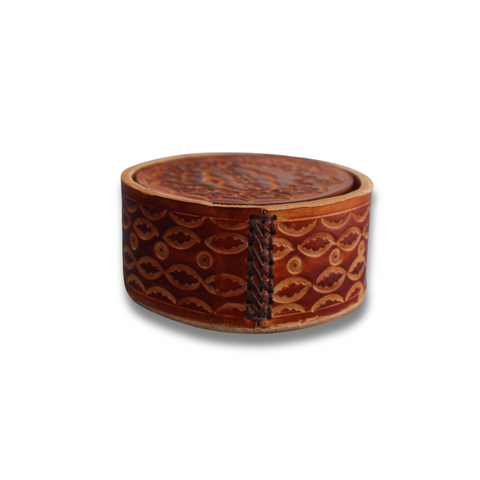 Brown leather coasters in coaster holder.