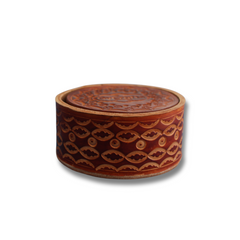 Brown coaster with a one-of-a-kind design, displayed in a coaster holder.