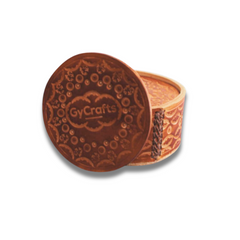Brown coaster with a one-of-a-kind design, displayed in front of the coaster holder.