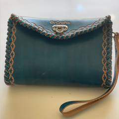 Blue Ituni wristlet made with 4 oz Argentinian leather with zip closure, a single strap with buckle and a beautiful flap. Made by Gy Crafts.