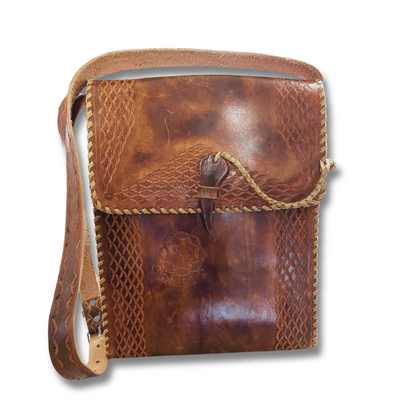 Brown Nickerie bag featuring a single strap, flap closure and made from Argentinian leather. Made by Gy Crafts.