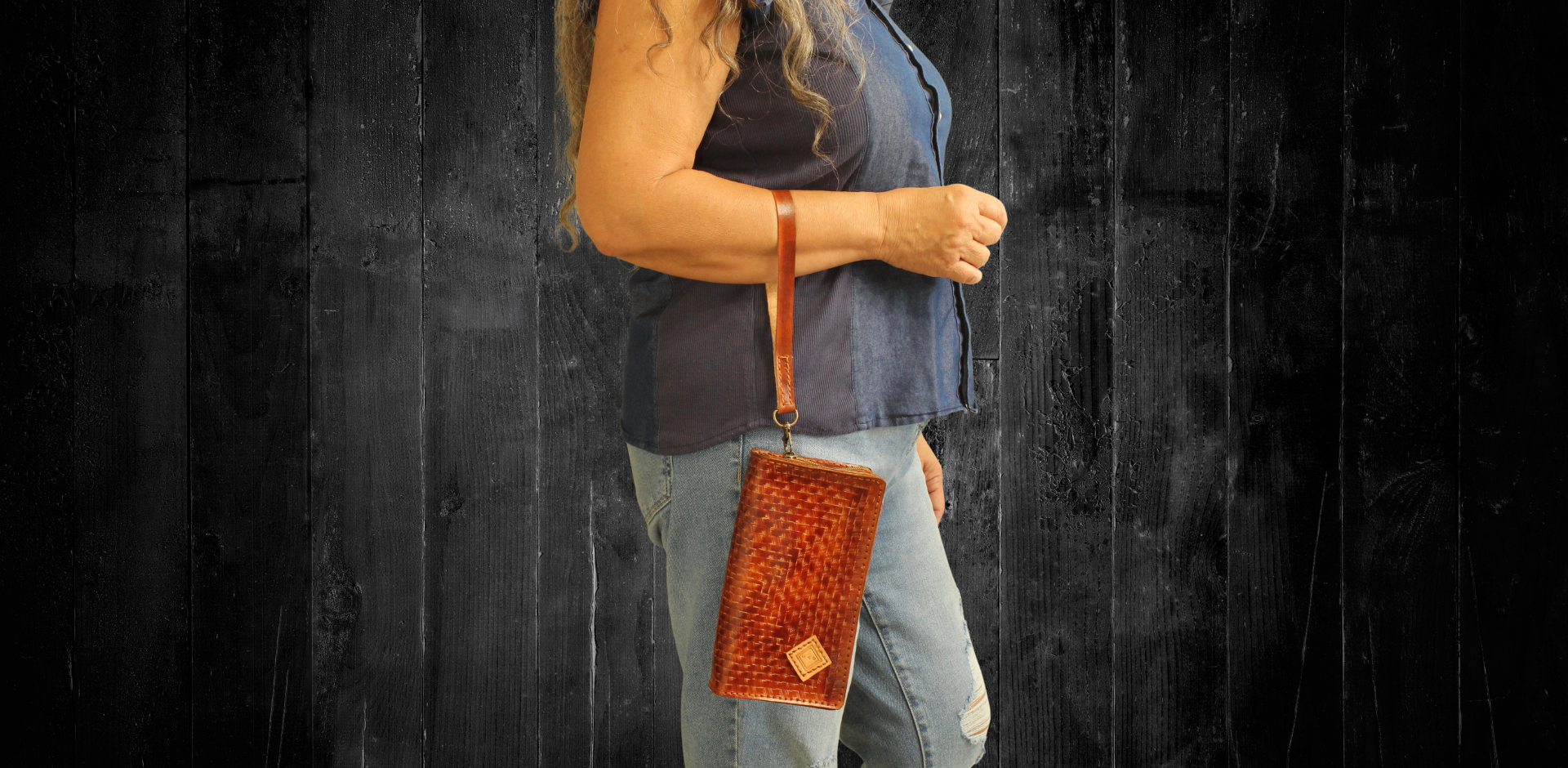 Model displaying brown Puruni wristlet hanging from her hand closer to her wrist. Made by Gy Crafts.