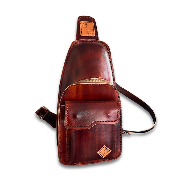 Brown Moruca leather bag displayed on a white background featuring a strap, inner and outer pockets