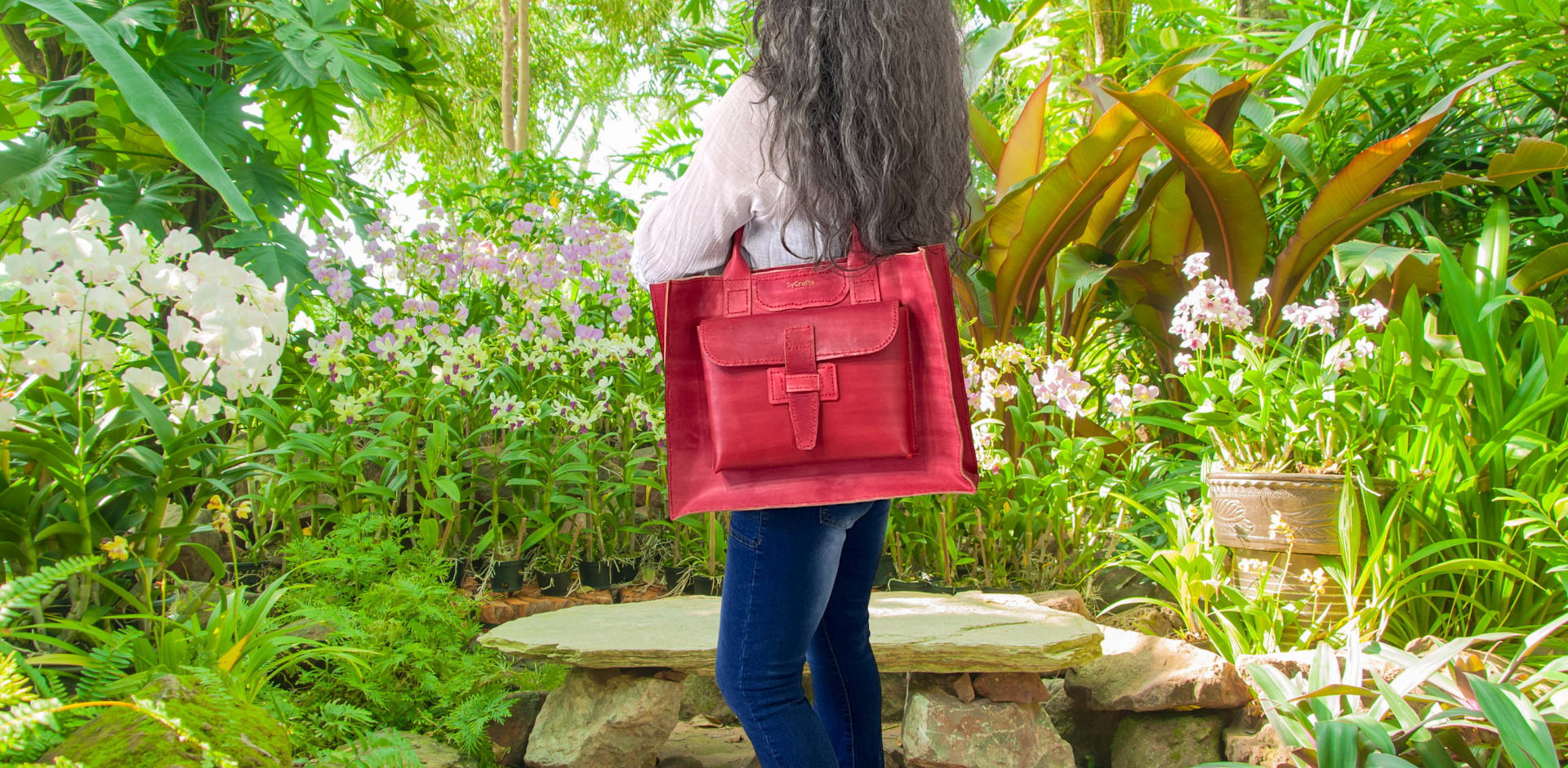 Model displaying red Bohemia bag featuring double shoulder straps, outside pockets and a floating interior. Made by Gy Crafts