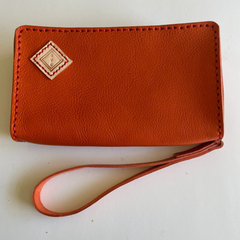 Brown Puruni wristlet, featuring zip closure, single strap and hand stamped. Made by Gy Crafts