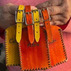 Model holding baggage tags in colours yellow and light brown made by Gy Crafts