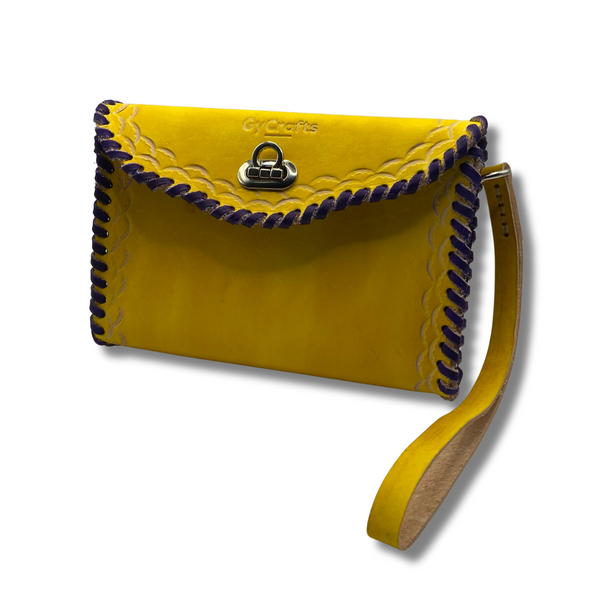 Yellow and purple Ituni wristlet made with 4 oz Argentinian leather with zip closure, a single strap with buckle and a beautiful flap.