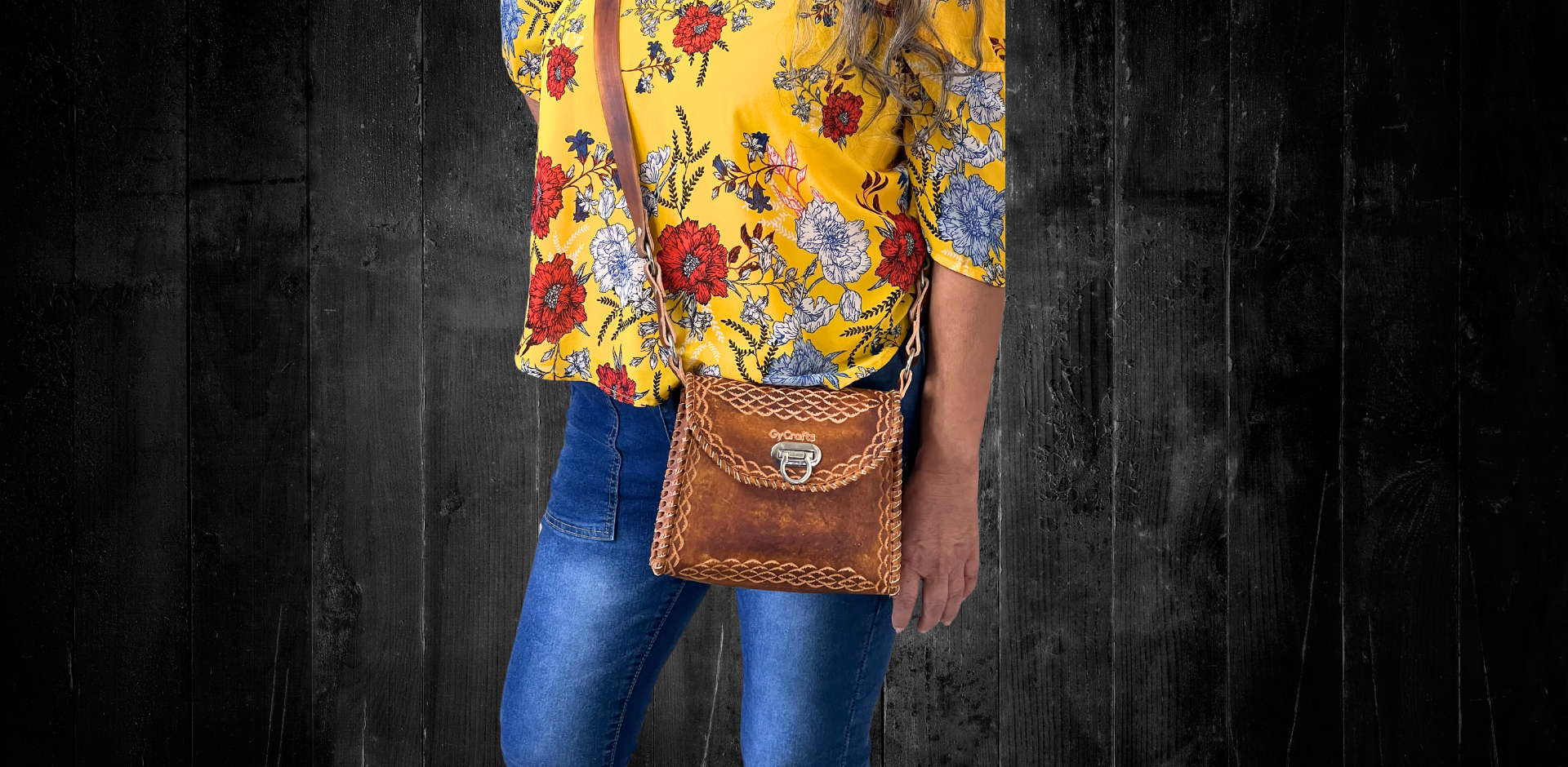 Model displaying brown Wonotobo bag featuring a single strap across her body and has a flap closure. Made by Gy Crafts.