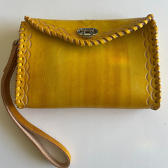 Yellow Ituni wristlet made with 4 oz Argentinian leather with zip closure, a single strap with buckle and a beautiful flap. Made by Gy Crafts.